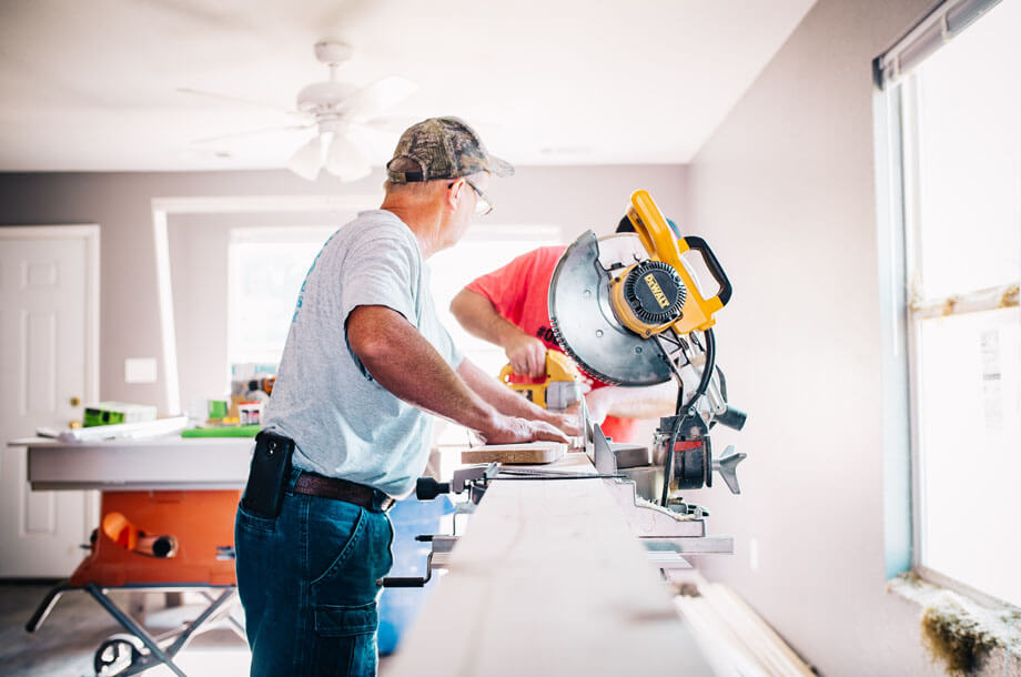 Contractors working with miter saw photo | Allenbrook Liability Insurance