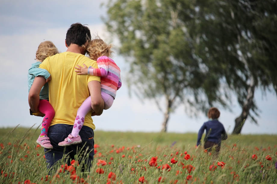 Young father with 3 children in field photo | Allenbrook Life Insurance